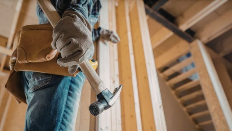 Construction worker doing repairs on a house