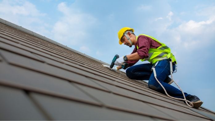 Man working on house roof