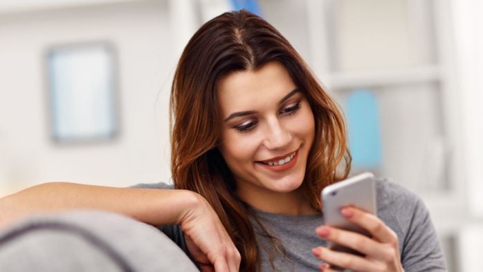 Woman using mobile phone from home